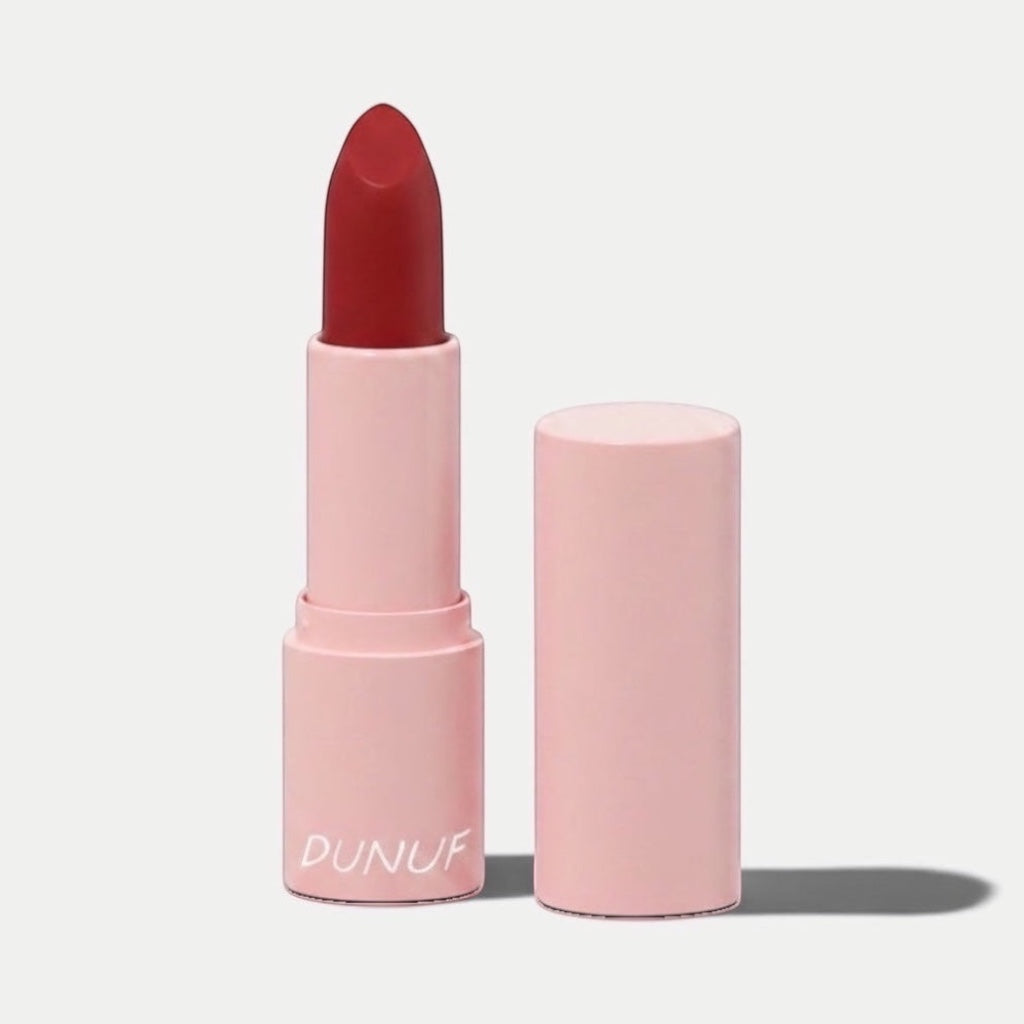 SOLA-GLOW lipstick in a deep red shade with a matte finish, presented in a light pink cylindrical tube.