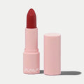 SOLA-GLOW lipstick in a deep red shade with a matte finish, presented in a light pink cylindrical tube.